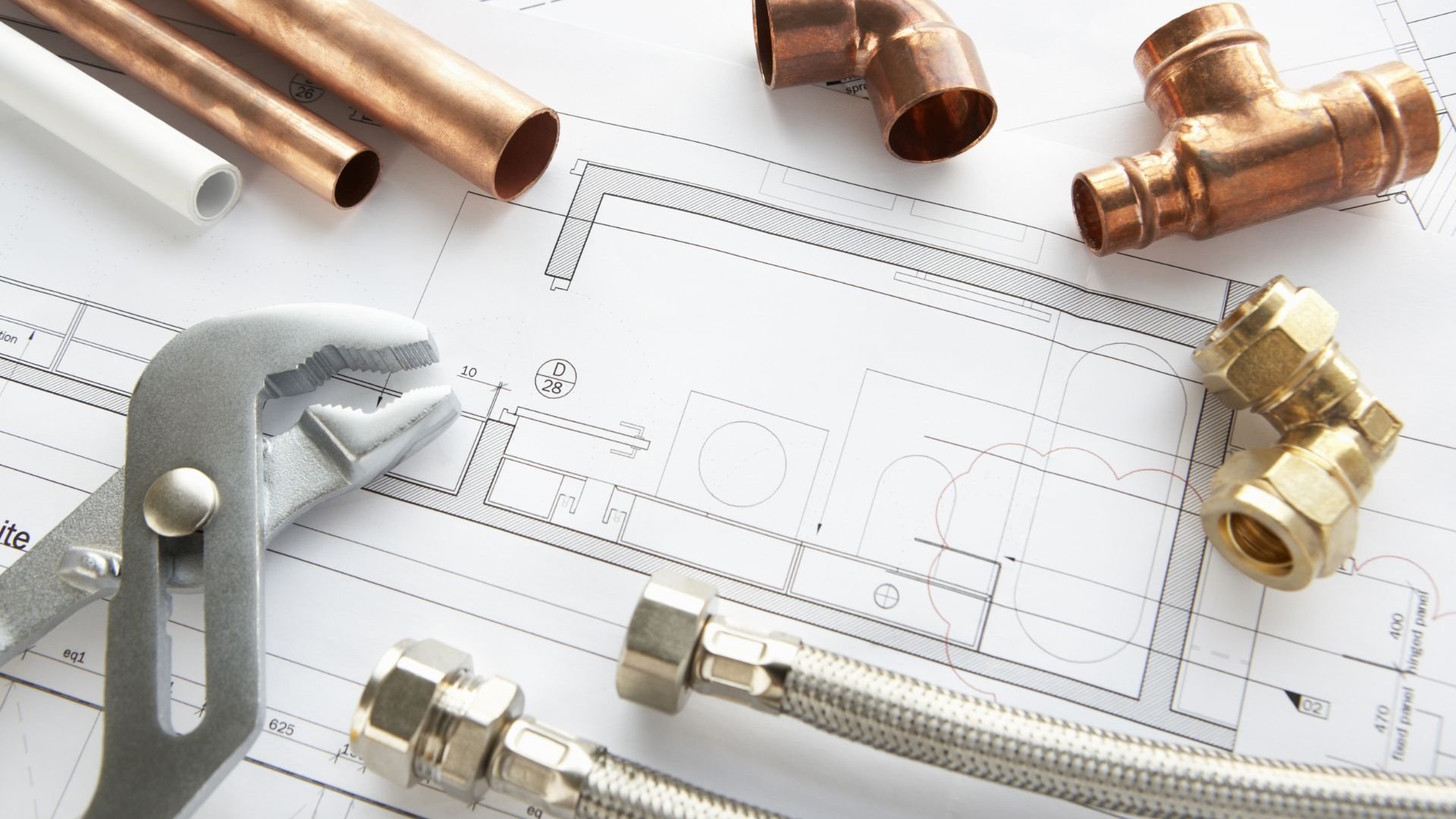 Plumbing pipes, fittings, and technical drawing for construction project
